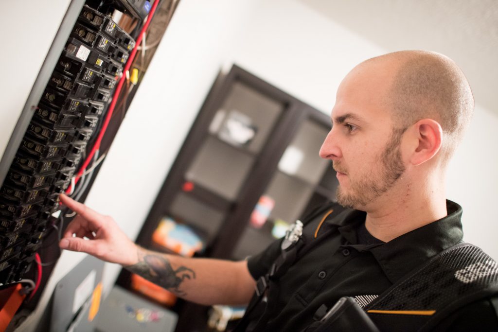 Home inspector inspecting service panel
